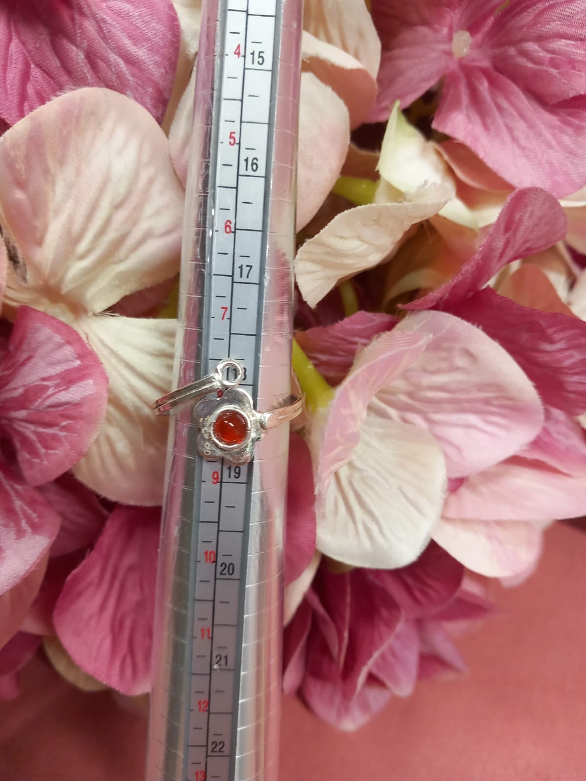 Sterling silver ring with red mineral stone in a flower