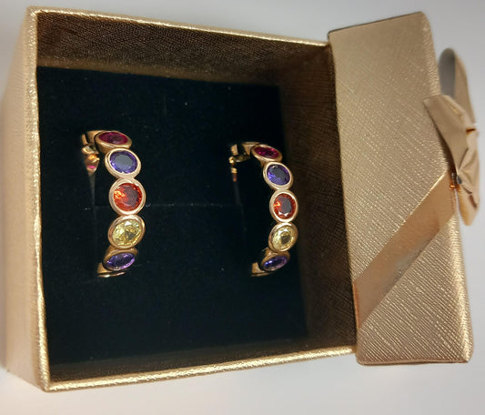 Hoop earrings with romantic discolored zircons on a gold or silver background